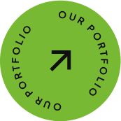 A green circle with a black upward-right arrow in the center and the words OUR PORTFOLIO written twice around the edge in a circular pattern.