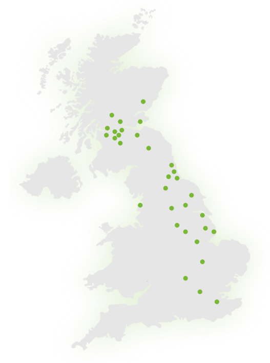 A grey map of the United Kingdom with multiple green dots marking various locations across England, Scotland, and Wales.