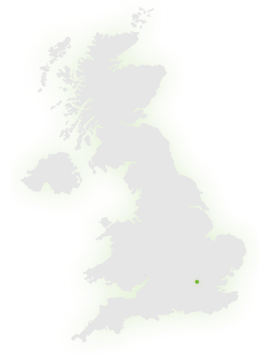 A light grey map of the United Kingdom with a small green dot marking a location in southeast England.
