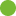 A blurred green circular shape with a pattern resembling a mandala or a flower, set against a lighter background.